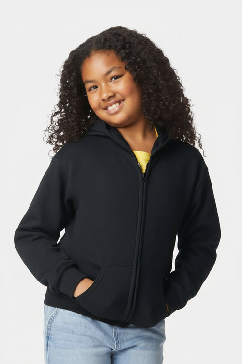 Child wearing a black jacket with a plain background