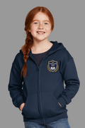 A young girl with red hair in a braid wearing a navy blue zip-up hoodie with a school crest on the chest, standing against a light gray background.