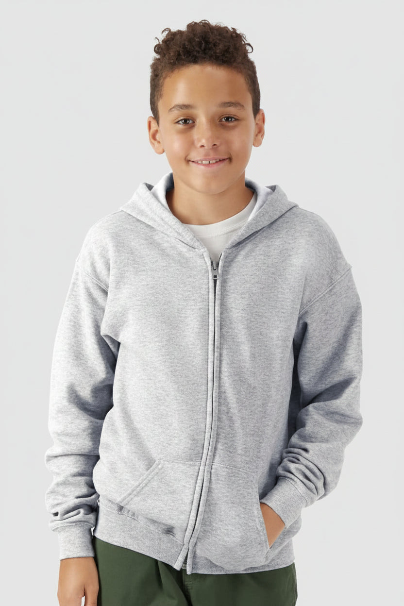 Child wearing a gray hoodie on a plain background